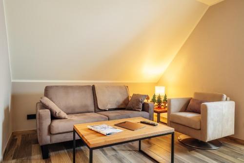a living room with a couch and a table at Baude III in Braunlage