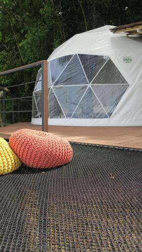 two cushions on the floor in front of a tent at Touch Glamping Koh Yao Noi ทัช แกรมปิ้ง เกาะยาวน้อย in Ko Yao Noi