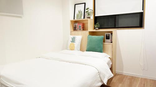 a bedroom with two beds and a flat screen tv at dandelion house in Tokyo