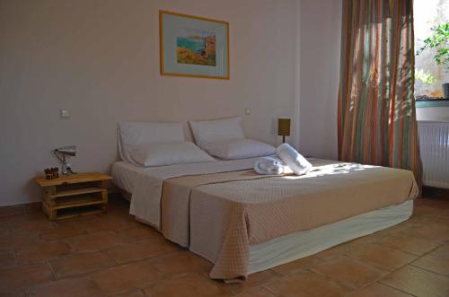a bedroom with a bed and a table and a window at Casa Muraglia Studio/Studio Under Castle in Travliáta