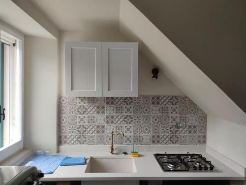 a kitchen with a sink and a stove at B&B NONNA GINA in Manoppello