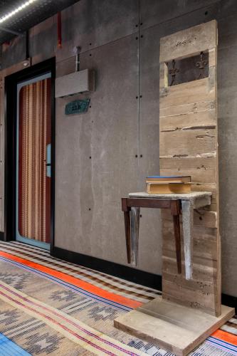 a wooden table in a room with a wall at JAM Lisbon in Lisbon