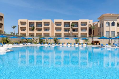 a large swimming pool in front of a hotel at Cleopatra Luxury Resort Sharm - Adults Only 16 years plus in Sharm El Sheikh