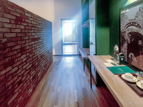 a dining room with a brick wall and a table at LOKAL Rooms x Murree Kashmir Point in Murree