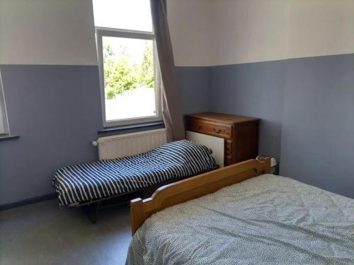Schlafzimmer mit einem Bett und einem Fenster in der Unterkunft City House - Idéal pour groupes in Mons