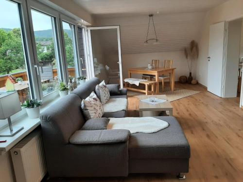 a living room with a couch and a table at Ferienwohnung Marion in Wallenborn