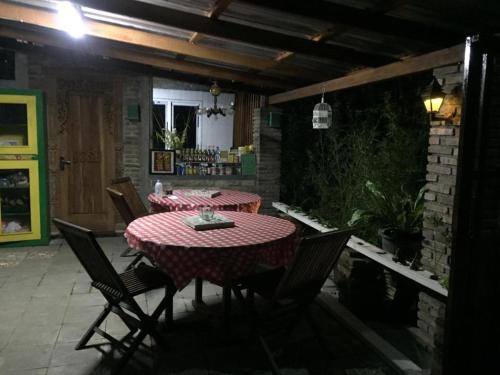 a patio with a table and chairs in a room at De Ikut Bojo Homestay in Magelang