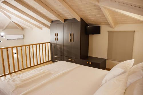 a bedroom with a large bed and a cabinet at La villa events in Amaliás