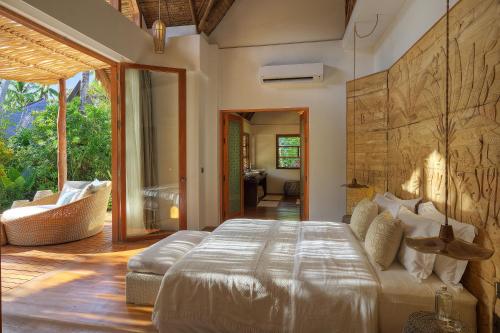 a bedroom with a large bed in a room at Nay Palad Hideaway - All Inclusive Stay in General Luna