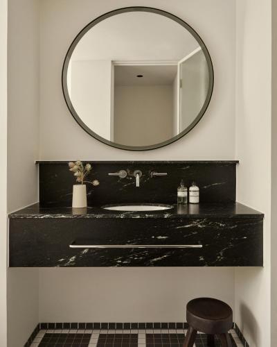 a bathroom with a black sink and a mirror at Morgan & Mees Rotterdam in Rotterdam