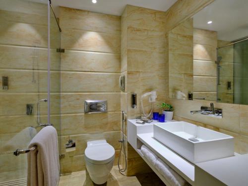 a bathroom with a sink and a toilet and a shower at Fortune Inn Heritage Walk Amritsar in Amritsar