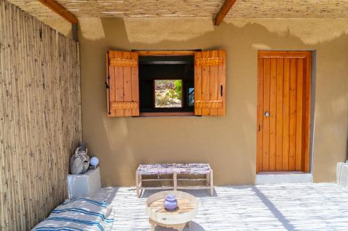 a room with a table and a window at Exoristoi Nature Suites in Gavdos