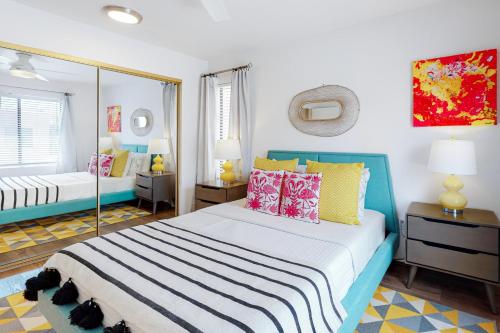 a bedroom with a blue and white bed with pillows at Canyon Shores Getaway in Cathedral City