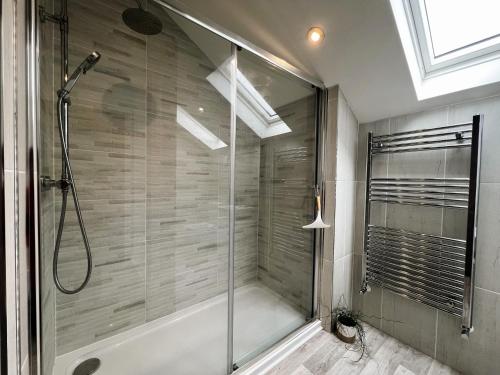 a shower with a glass door in a bathroom at Seagrass in Sandown