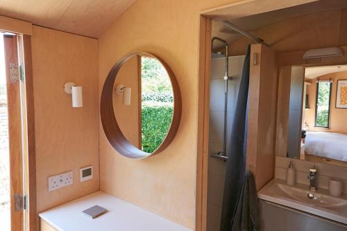 a small bathroom with a mirror and a sink at Hut64 in Shootend
