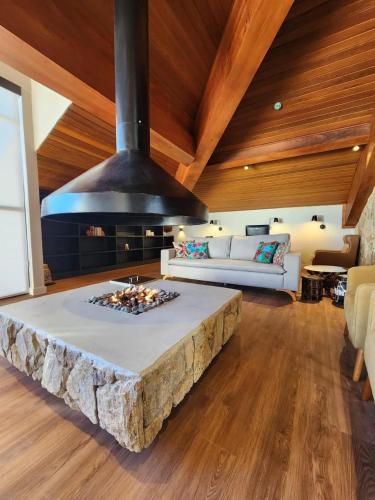 a living room with a large bed in a room at Quarto no Wanderlust Experience Hotel in Campos do Jordão