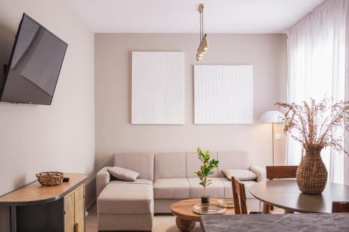 a living room with a couch and a table at Apartamentos Martalia Áticos Deluxe in Ronda