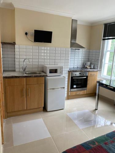 a kitchen with a sink and a stove top oven at Studio to let in Covent Garden with kitchen in London