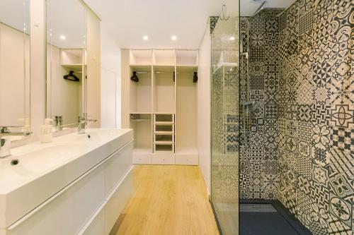 a bathroom with a shower and a white sink at Next to the Trees and the Sea in Estoril