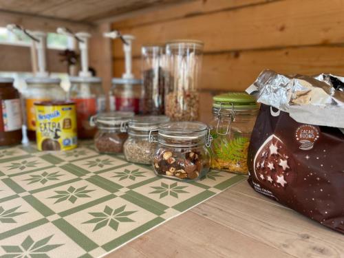 a counter with jars of food on a table at Le stanze di chiara in Torre Lapillo
