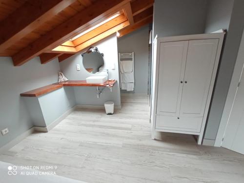 a bathroom with a sink and a mirror in a room at Posada las Albarcas in La Cavada