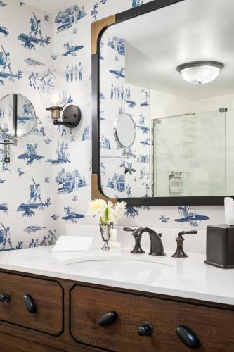 a bathroom with blue and white wallpaper and a sink at Graduate by Hilton Storrs in Storrs