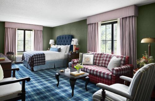 a hotel room with a bed and a living room at Graduate by Hilton Storrs in Storrs