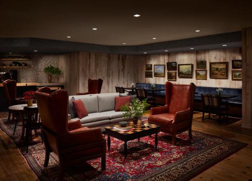 a living room with a couch and chairs and a table at Graduate by Hilton Storrs in Storrs