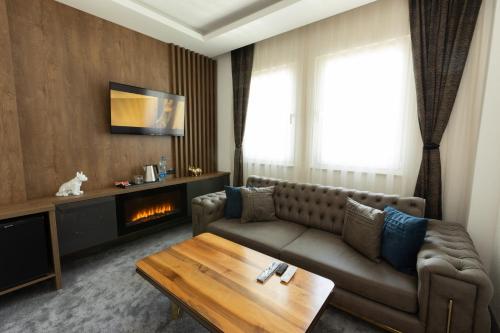 a living room with a couch and a fireplace at Hotel M Star Novi Pazar in Novi Pazar
