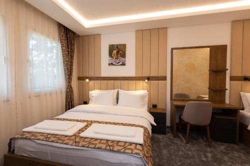 a hotel room with a bed and a desk at Hotel M Star Novi Pazar in Novi Pazar