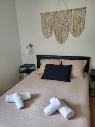 a bed with two white towels on it at La Grange - 10 couchages in Carla-de-Roquefort