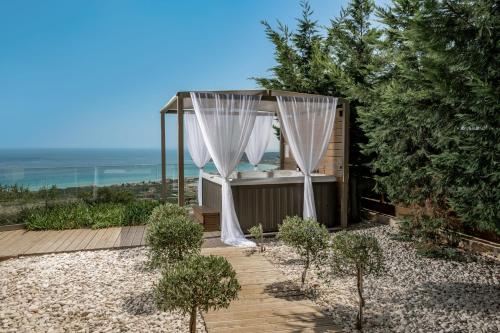 a gazebo with a shower in a garden at Artemis Villas - Spectacular Views & Ideal For Large Groups, By ZanteWize in Khartáta