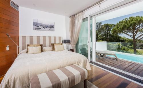 a bedroom with a bed and a large window at Sunny Lounge Apartment in Vale do Lobo