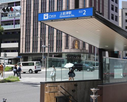 two people with an umbrella standing in front of a building at Chiyoda-Home　Osu-sakae-Subways-JR trin-Spa-parking spot-WIFI in Nagoya