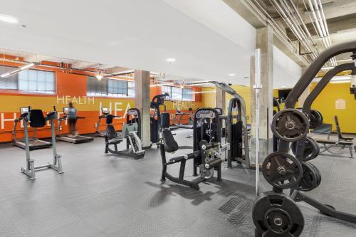 a gym with several treadmills and weights at Downtown Durham 2BR Apt Walk Everywhere & Wifi in Durham