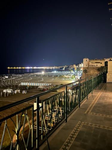 a view of a beach at night from a balcony at NEWHOUSE VICTORIA - Sea View Apartment in Nettuno