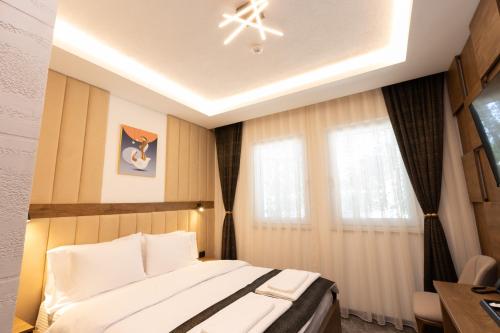 a bedroom with a large bed and a window at Hotel M Star Novi Pazar in Novi Pazar