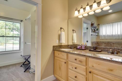 a bathroom with two sinks and a large mirror at Spacious Utah Retreat with Deck, Grill and Fire Pit! in Provo