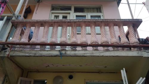a balcony of a building with birds sitting on it at Eka's Vacation House in Batumi