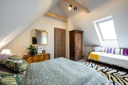 a bedroom with a bed and a mirror and a window at Boutique Chalet - Herke in Eitweg