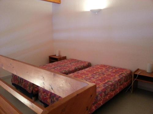 ein Hotelzimmer mit 2 Betten und einem Tisch in der Unterkunft Résidence des 3 Césars in Aulus-les-Bains