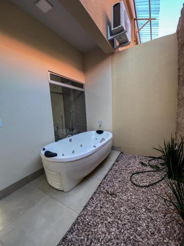 a bath tub sitting in the corner of a bathroom at Pousada Paraiso in Alto Paraíso de Goiás
