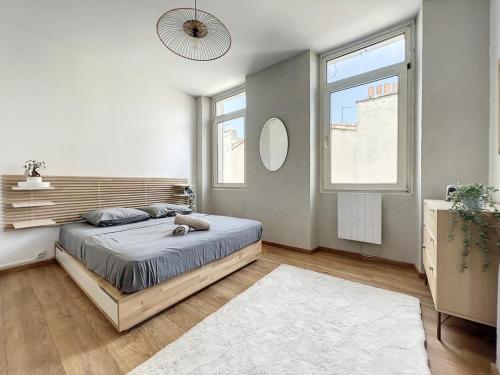 une chambre avec un lit et une grande fenêtre dans l'établissement Appartement Familial - Central & Spacieux - Les Frères de la Loc', à Marseille