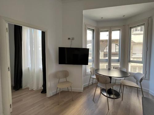 a living room with a table and chairs and a television at Express by gaiarooms in Barcelona