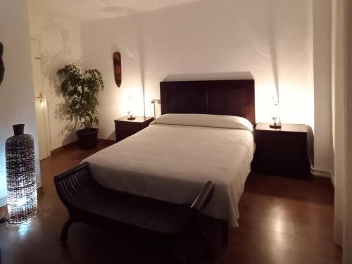 a bedroom with a large bed and two night stands at Casa Rural en Naval, Torre San Rafael in Naval