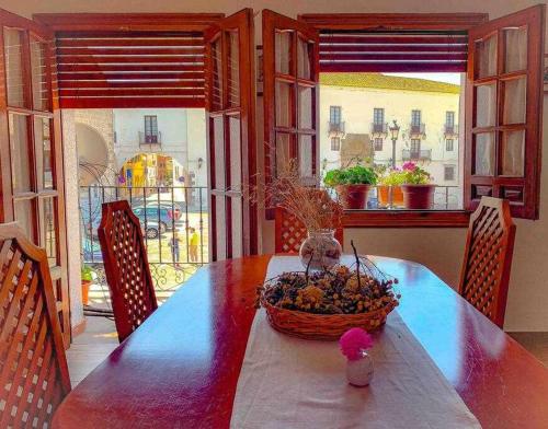 a dining room table with a basket of fruit on it at El Balcón de La Rosa in La Puebla de Montalbán