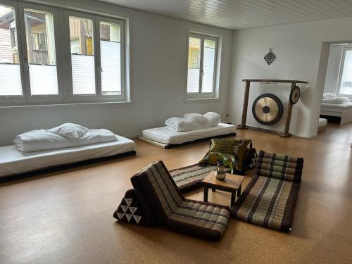 a living room with three beds and a couch at Wohnung in Burgdorf beim Schloss in Burgdorf