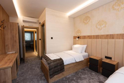 a hotel room with two beds and a bathroom at Hotel M Star Novi Pazar in Novi Pazar