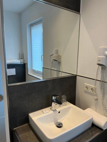 a bathroom with a sink and a mirror at Hochwald Lodge in Morbach