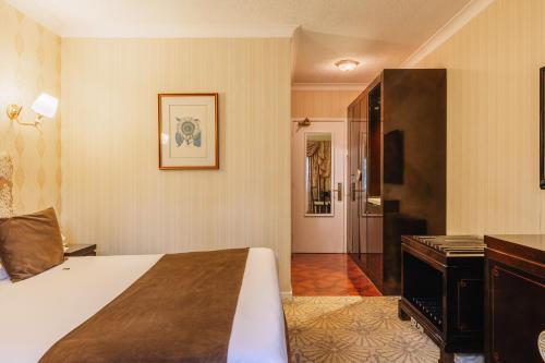 a hotel room with a bed and a desk at Muthu Belstead Brook Hotel in Ipswich